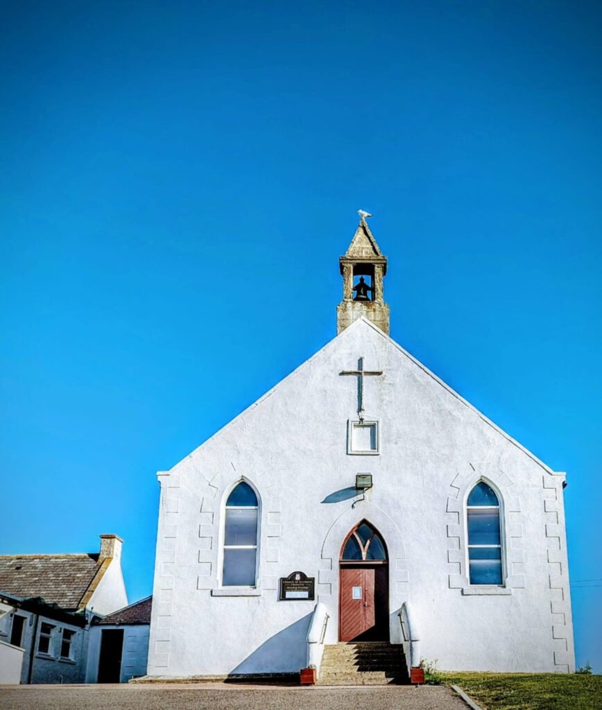 Findochty Church of Scotland against a clear blue sky.